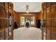 Well-lit office featuring wood paneling, a bay window, and double french door entry at 8261 Twin Pointe Cir, Indianapolis, IN 46236