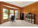 Bright office featuring wood paneling, a bay window, and neutral-toned carpet at 8261 Twin Pointe Cir, Indianapolis, IN 46236