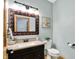 Elegant powder room featuring vanity, patterned mirror, and charming decor at 8261 Twin Pointe Cir, Indianapolis, IN 46236