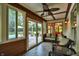 Bright sunroom with ample windows, patio access, and comfortable seating at 8261 Twin Pointe Cir, Indianapolis, IN 46236