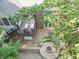 Aerial view showcasing a backyard with a fire pit, patio seating, and an elevated deck with lounge chairs at 8429 Catamaran Dr, Indianapolis, IN 46236