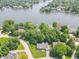 A high aerial view of the home surrounded by mature trees near a lake in a residential neighborhood at 8429 Catamaran Dr, Indianapolis, IN 46236
