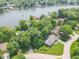 An aerial view of the home nestled among mature trees, close to a lake and surrounding neighborhood at 8429 Catamaran Dr, Indianapolis, IN 46236