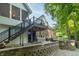 Charming backyard featuring a stone patio with seating, a hanging swing, and a covered porch at 8429 Catamaran Dr, Indianapolis, IN 46236