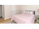 Bright bedroom with a red and white striped bed, side tables, and a view to an adjacent room at 8429 Catamaran Dr, Indianapolis, IN 46236