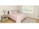 Cozy bedroom featuring a comfortable bed, side tables, and a bright window view at 8429 Catamaran Dr, Indianapolis, IN 46236