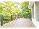 Outdoor deck with black metal railing and various potted plants offering serene views of the surrounding greenery at 8429 Catamaran Dr, Indianapolis, IN 46236