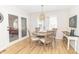 Dining area featuring a modern light fixture, wood-look floors, and French doors leading to another room at 8429 Catamaran Dr, Indianapolis, IN 46236