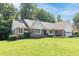 Charming single-story brick home with manicured lawn and complemented by beautiful, mature trees at 8429 Catamaran Dr, Indianapolis, IN 46236