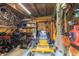 This spacious garage includes lawn equipment, tools, storage shelving, and overhead bicycle storage racks at 8429 Catamaran Dr, Indianapolis, IN 46236