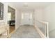 Bright hallway with a decorative rug, white front door with glass panes, and entry to other rooms at 8429 Catamaran Dr, Indianapolis, IN 46236