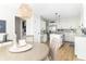 Open kitchen featuring stainless appliances, white cabinets, an island cooktop, and eat-in kitchen seating at 8429 Catamaran Dr, Indianapolis, IN 46236