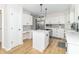 Updated kitchen with an island cooktop, stainless steel appliances, white cabinets, and a desk nook at 8429 Catamaran Dr, Indianapolis, IN 46236