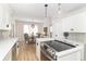 Updated kitchen featuring stainless steel appliances, white cabinets, an island cooktop, and eat-in kitchen seating at 8429 Catamaran Dr, Indianapolis, IN 46236