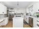 Open kitchen featuring white cabinets, stainless steel appliances, eat-in kitchen, and a central island cooktop at 8429 Catamaran Dr, Indianapolis, IN 46236
