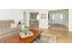 Open-concept living room showcasing wood-look floors, comfortable seating, and a view into the adjacent dining room and entry at 8429 Catamaran Dr, Indianapolis, IN 46236