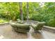 Stone patio with green outdoor seating arranged around a fire pit, perfect for entertaining at 8429 Catamaran Dr, Indianapolis, IN 46236