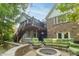 This beautiful backyard patio features comfortable green seating, a cozy fire pit, and string lights at 8429 Catamaran Dr, Indianapolis, IN 46236