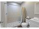 Tiled shower with a built-in showerhead, complemented by a vanity with a sink and toilet at 8720 N Deer Crossing Blvd, McCordsville, IN 46055