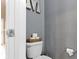 Cozy powder room with a toilet, storage and gray painted walls at 8720 N Deer Crossing Blvd, McCordsville, IN 46055