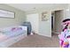 Cute bedroom features a single bed, flower decorations and a sign that reads, 'Jesus Loves Me' at 8720 N Deer Crossing Blvd, McCordsville, IN 46055