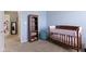 Cozy Bedroom with blue walls, a wooden crib, bookshelf, and comfortable beanbag chair at 8720 N Deer Crossing Blvd, McCordsville, IN 46055