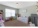 Cozy bedroom is decorated with multiple toys, a single bed and a sign that says, 'Jesus Loves Me' at 8720 N Deer Crossing Blvd, McCordsville, IN 46055
