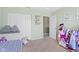 Well-lit bedroom is decorated with a flower 'E', toys, a single bed, and pink decorations at 8720 N Deer Crossing Blvd, McCordsville, IN 46055