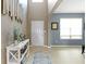 Welcoming entryway featuring light hardwood floors, neutral walls, and stylish decor, complemented by an archway and natural light at 8720 N Deer Crossing Blvd, McCordsville, IN 46055