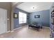 Bright living room featuring blue walls, arched doorways, and comfortable seating, with natural light streaming through the window at 8720 N Deer Crossing Blvd, McCordsville, IN 46055