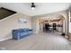 Open-concept living room with hardwood floors leading to a kitchen with white cabinetry at 8720 N Deer Crossing Blvd, McCordsville, IN 46055
