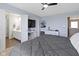 Comfortable main bedroom features light blue walls, ceiling fan, TV, and an ensuite bathroom with white vanity at 8720 N Deer Crossing Blvd, McCordsville, IN 46055