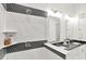 Elegant bathroom featuring black and white tiles in the shower, dual sink vanity, and a modern design at 920 Veterans Way # 204, Carmel, IN 46032