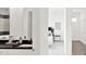 Elegant bathroom flows into bedroom and features modern fixtures, black countertops, and detailed tile work at 920 Veterans Way # 204, Carmel, IN 46032