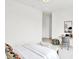 Comfortable bedroom with modern decor, featuring a work desk, comfortable chair, and a large window at 920 Veterans Way # 204, Carmel, IN 46032