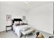 Spacious bedroom with stylish furnishings, including a black headboard bed, bench, and side tables at 920 Veterans Way # 204, Carmel, IN 46032