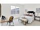Bright and airy bedroom featuring a large window, comfortable furnishings, and stylish decor at 920 Veterans Way # 204, Carmel, IN 46032