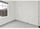 Bright bedroom with neutral carpet, large window, closet doors, and a minimalist design at 920 Veterans Way # 204, Carmel, IN 46032