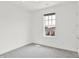 Bright bedroom with neutral carpet, one window, and a modern minimalist design at 920 Veterans Way # 204, Carmel, IN 46032