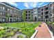 Beautiful courtyard view with benches, green lawn, and brick walkways, surrounded by elegant brick buildings at 920 Veterans Way # 204, Carmel, IN 46032