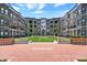 Beautiful courtyard featuring well-manicured lawns, benches and walkways surrounded by brick apartment buildings at 920 Veterans Way # 204, Carmel, IN 46032