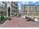 Charming outdoor courtyard with brick paving, seating areas, and a central water fountain at 920 Veterans Way # 204, Carmel, IN 46032