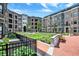 Serene courtyard featuring lush greenery, brick pathways, benches, and well-maintained landscaping at 920 Veterans Way # 204, Carmel, IN 46032