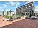 Outdoor courtyard with tables, seating, and a fountain, adjacent to landscaped areas and building exteriors at 920 Veterans Way # 204, Carmel, IN 46032