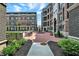 Beautiful outdoor seating area surrounding a fountain between apartment buildings in a landscaped courtyard at 920 Veterans Way # 204, Carmel, IN 46032