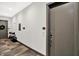 Hallway with gray walls, door 204, and modern flooring, featuring stylish unit entryways at 920 Veterans Way # 204, Carmel, IN 46032