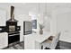 Modern kitchen boasts white cabinets, stainless steel appliances, a sleek range hood, and an island with comfortable seating at 920 Veterans Way # 204, Carmel, IN 46032