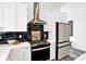 Modern kitchen boasts white cabinets, stainless steel appliances, and stylish black subway tile backsplash at 920 Veterans Way # 204, Carmel, IN 46032
