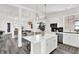 Bright, open-concept kitchen with a large center island, stainless appliances, and a view to the dining and living areas at 920 Veterans Way # 204, Carmel, IN 46032
