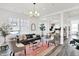 Bright living room with large windows, modern furnishings, and an open floor plan connecting to the dining and kitchen areas at 920 Veterans Way # 204, Carmel, IN 46032
